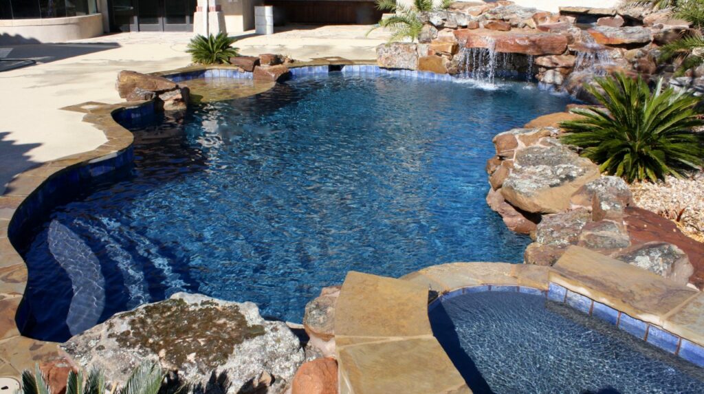 Freeform Pool with raised spa and moss rock water features