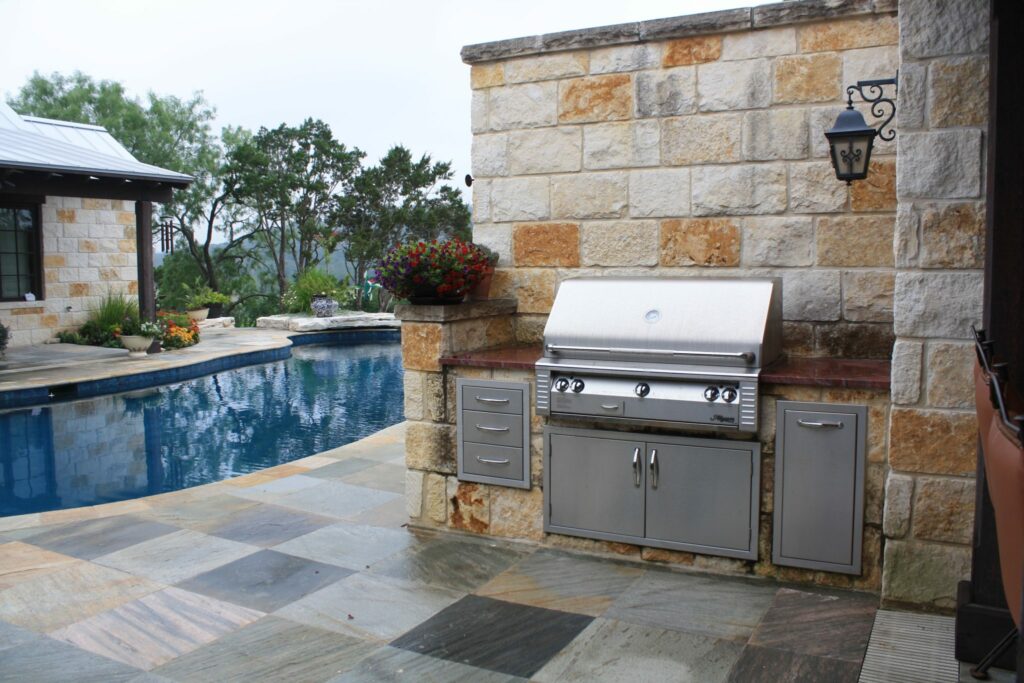 Outdoor Kitchen with Granite Countertops and Stone faced