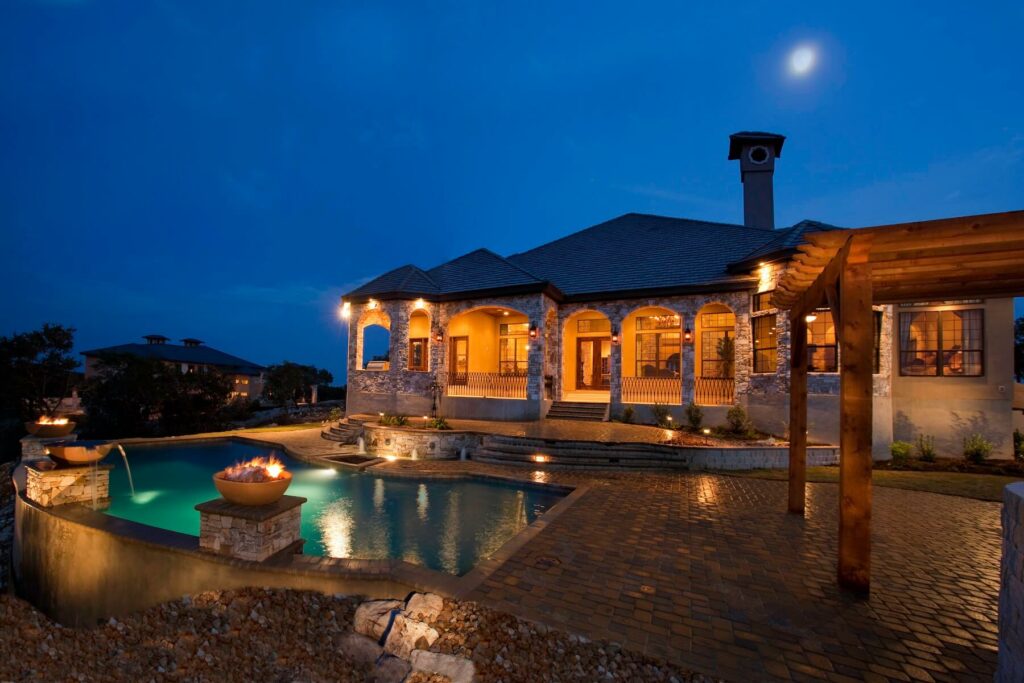 Custom-pool-with-water-and-fire-woks-paver-deck-outdoor-living-space-bubblers-and-LED-lighting