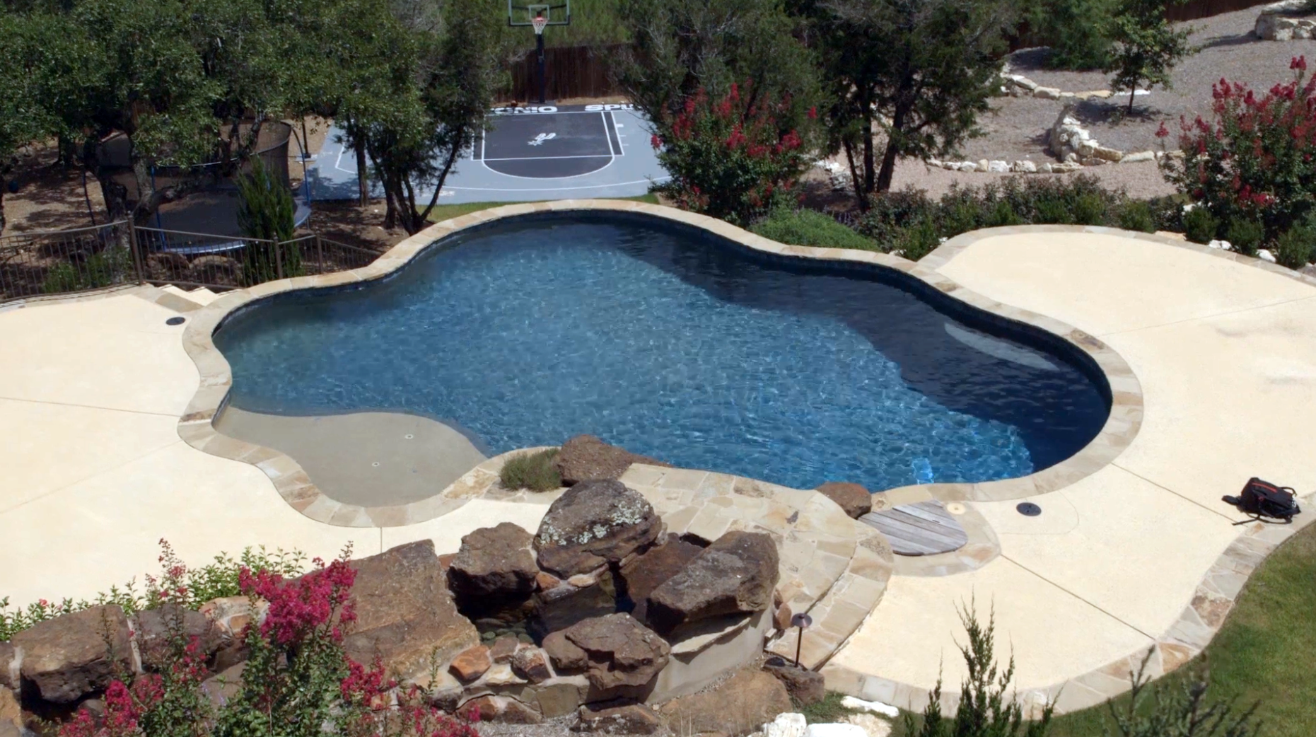 Freeform with dual color plaster and large Moss Rock Water Feature